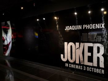 Close-up of text on glass at night