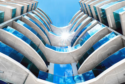 Low angle view of modern building against blue sky