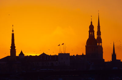 A beautiful cityscape of riga, latvia during sunrise. church towers against colorful sky. 