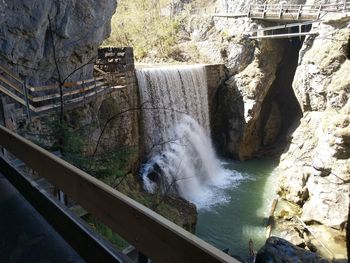 High angle view of waterfall amidst rocks