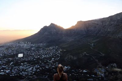 Man photographing on mountain against sky