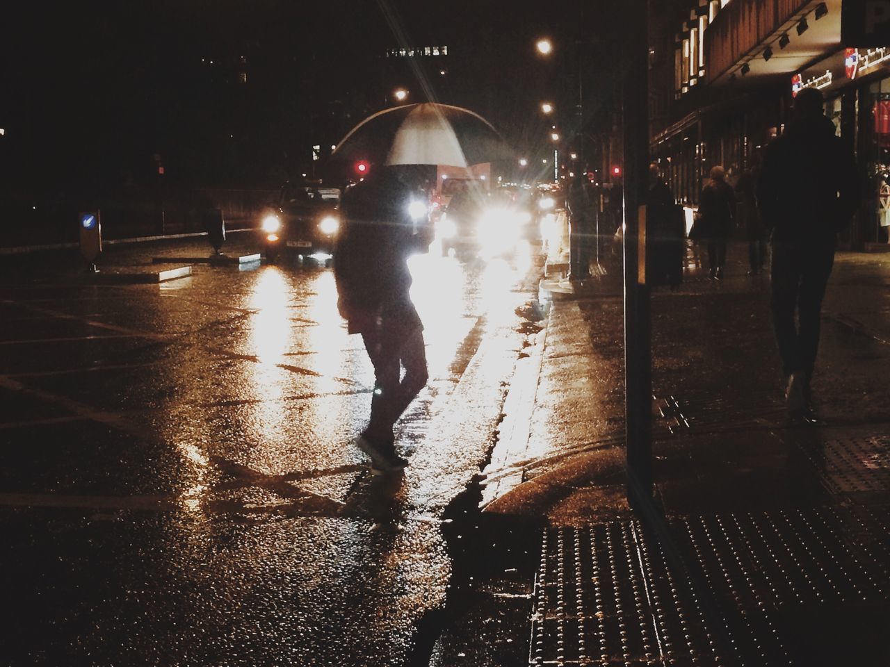 night, street, lifestyles, illuminated, walking, rain, full length, wet, city life, men, city, leisure activity, transportation, person, building exterior, umbrella, reflection, architecture