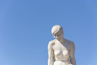 Low angle view of statue against clear blue sky