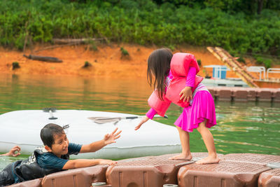 Rear view of women on pink lake