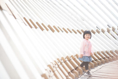 Portrait of girl standing against wall