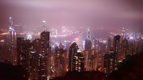 Aerial view of illuminated buildings in city at night