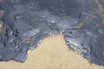 High angle view of snow on wet land