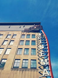 Low angle view of flag against blue sky