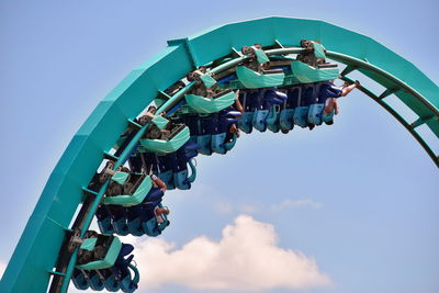 Low angle view of amusement park ride against sky