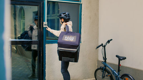 Rear view of woman standing in city