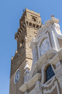 Low angle view of clock tower against sky