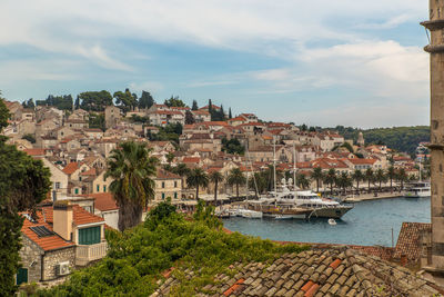 Townscape by sea against sky