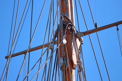 Low angle view of sailboat against clear blue sky