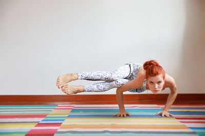 Young woman exercising on floor at home
