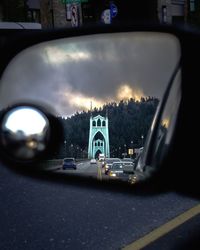 Cars on road in city against sky