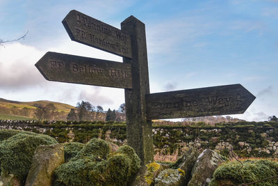 Low angle view of road sign against sky