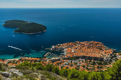 High angle view of buildings by sea