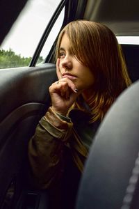 Portrait of teenage girl sitting in car