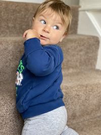 Portrait of cute girl sitting on floor