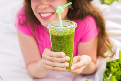 Midsection of woman drinking glass