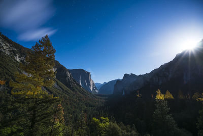 Scenic view of mountains against bright sun