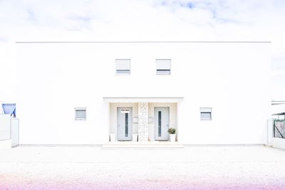 Closed door of building against sky