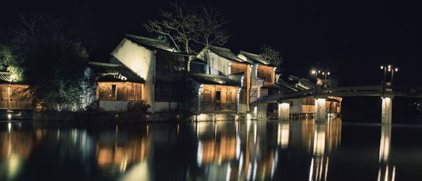 Reflection of illuminated buildings in water at night