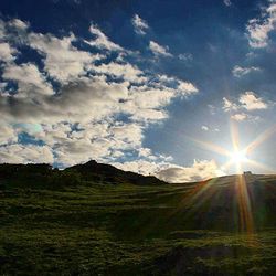 Scenic view of landscape against cloudy sky