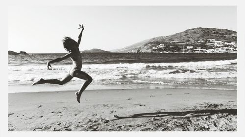 Full length of man on beach against clear sky