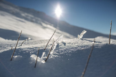 Scenic view of frozen lake against sky during sunny day