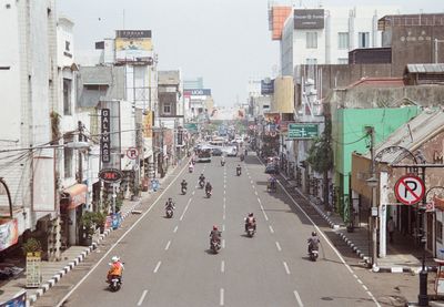 Vehicles on road along buildings