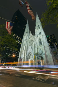 Light trail on street against st patrick cathedral in manhattan at night