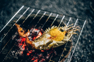 High angle view of meat on barbecue grill