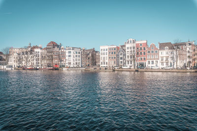 Scenic view of river against clear blue sky