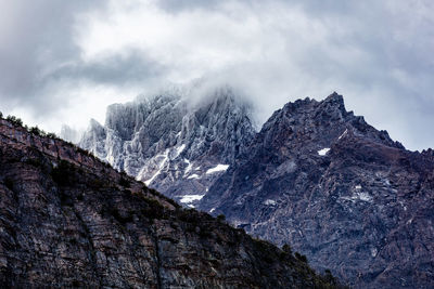 Low angle view of rocky mountains against sky