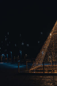 Illuminated city against sky at night
