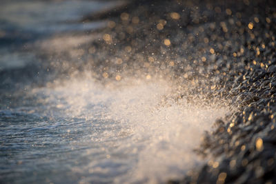 Wave on black rocks