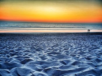 Scenic view of beach against sky during sunset