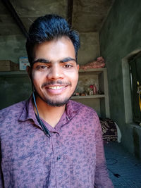 Portrait of smiling young man standing outdoors