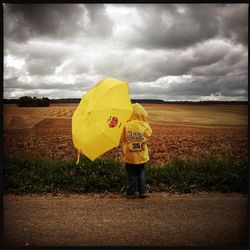 Scenic view of field against cloudy sky