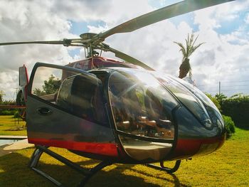 Close-up of motorcycle against cloudy sky