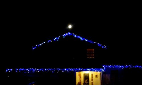 Low angle view of illuminated lights at night