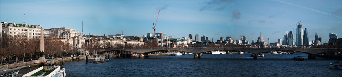 Bridge over river with buildings in background