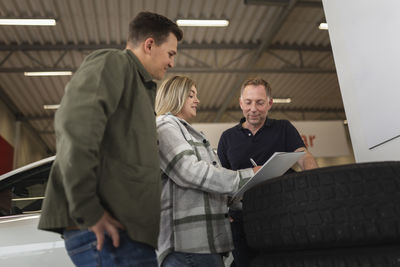 Customers in car dealership office