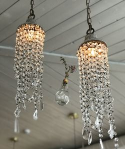 Low angle view of illuminated chandelier hanging on ceiling