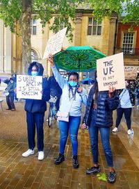 Group of people against building in city