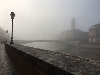 View of river in city during foggy weather