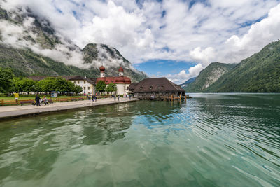 Scenic view of lake and buildings against sky