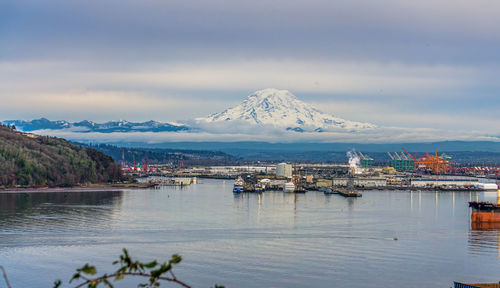 Mount rainier covered with snow behind the port of tacoma.