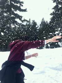 Man playing on snow on field